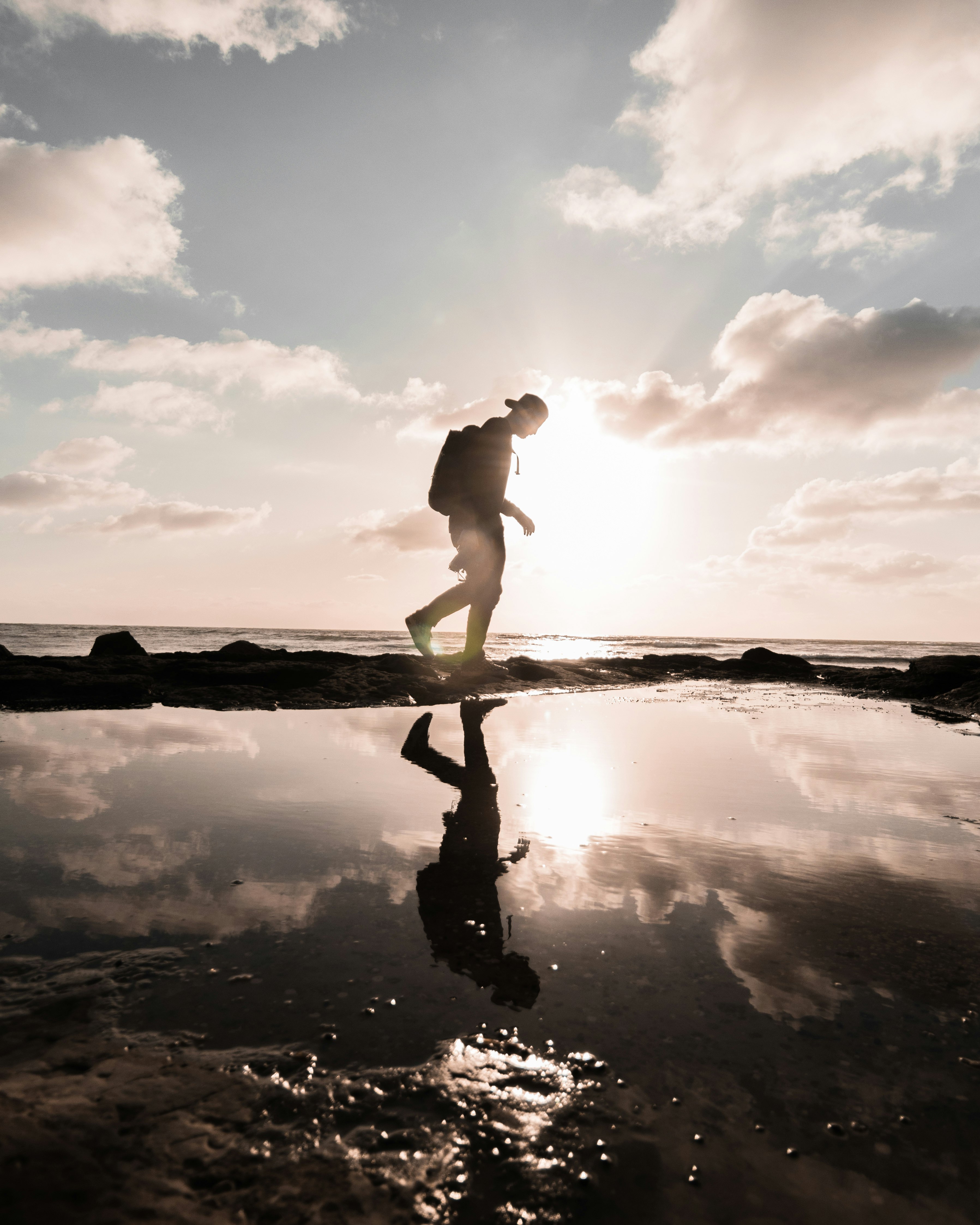 man in black shorts standing on water during daytime